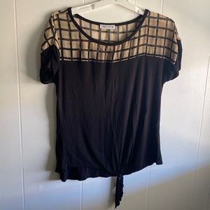 Checkered tan and black shirt. Sheer at top with a bow tie at the bottom